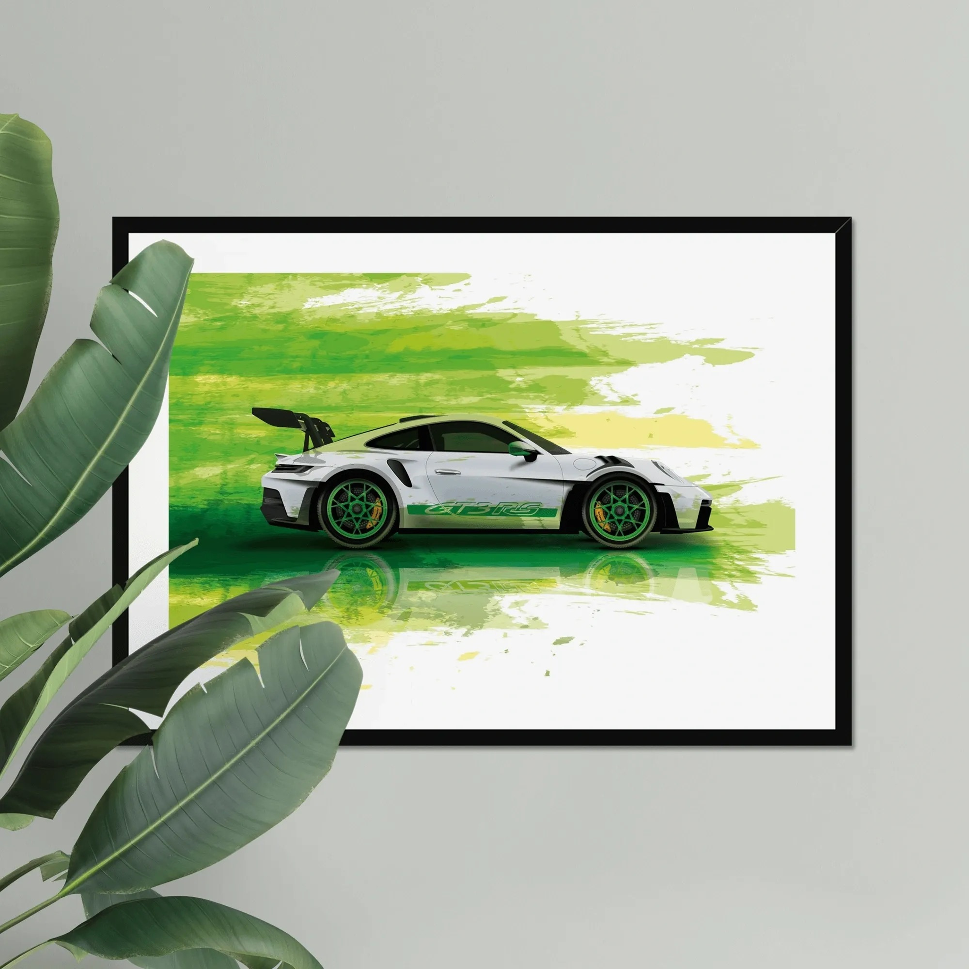 Framed artwork of a white sports car on a green abstract background, leaning against a light gray wall with a plant to the left.