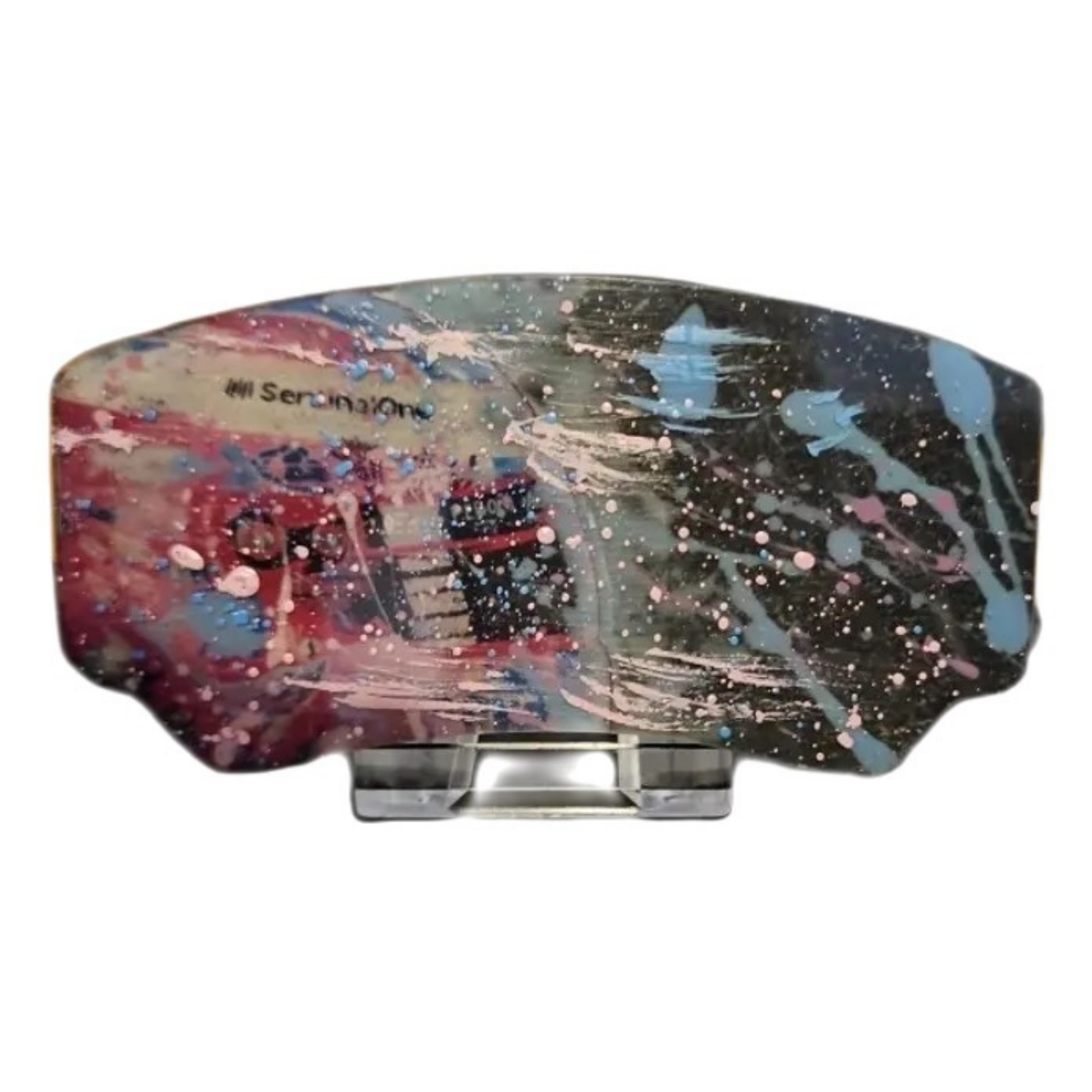 Colorful abstract art piece on a stand with 'All Seeing One' branding.